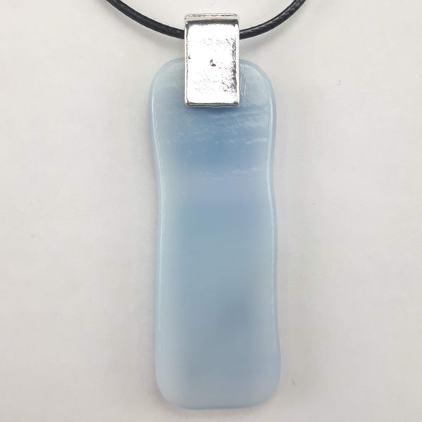 back of blue glass pendant on white background